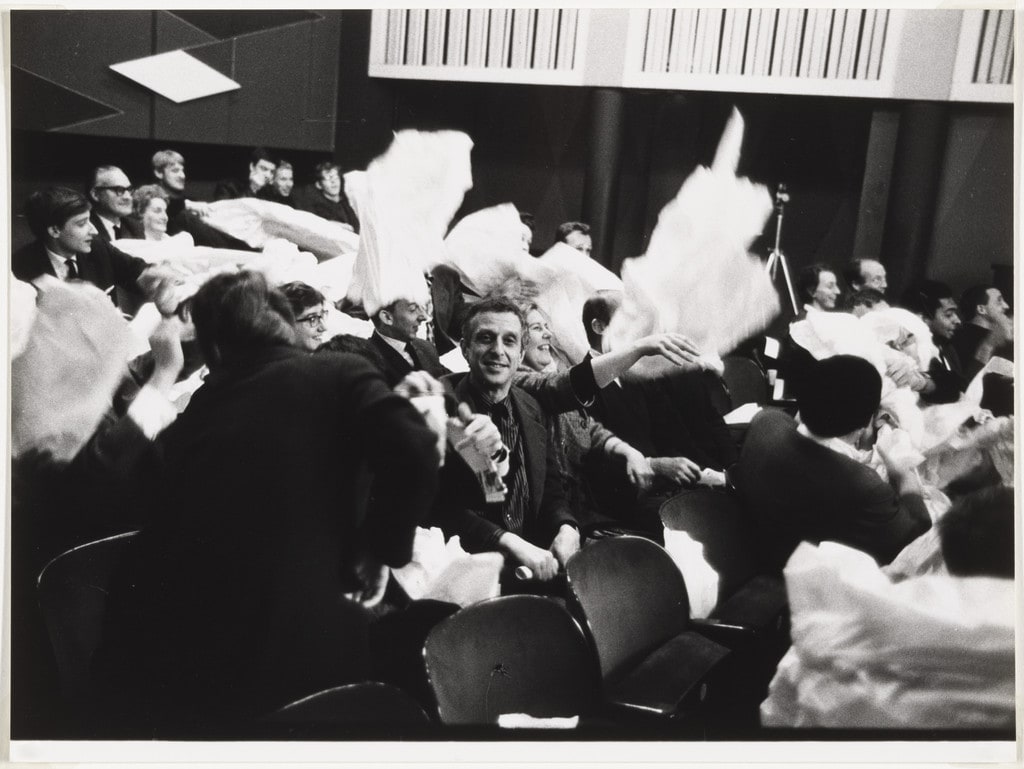 Audience members participating in Paper Piece (1960), performed during Fluxus Festival/Theatre Compositions/Street Compositions/Exhibits/Electronic Music, Hypokriterion Theater, Amsterdam, June 23, 1963