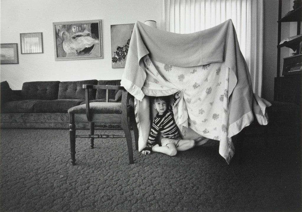 Some days when there is no one to play with I build Glenn a tent play house out of two chairs and two blankets.