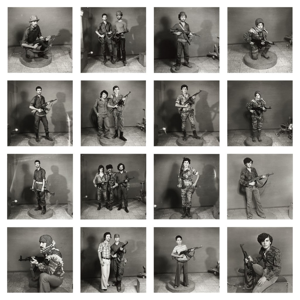 After They Got the Right to Arms. Fourteen young men posing with guns.