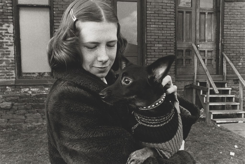 Girl Holding Small Black Dog