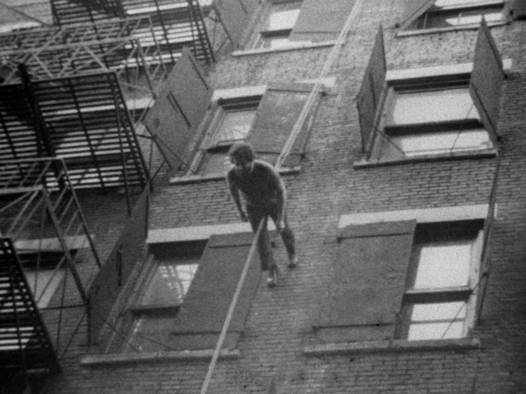 Man Walking Down the Side of a Building