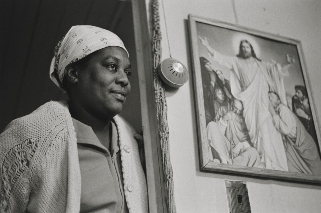 Susie Standing next to a Holy Picture in her Living Room, Daufuskie Island, South Carolina