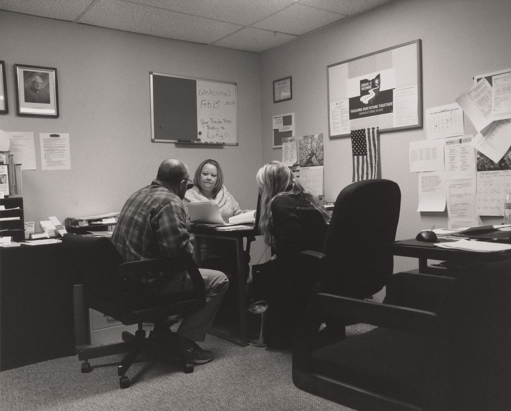 Customer service representatives Christina Defelice and Angela Ralston preparing paperwork for a co-worker after his shift in the Transition Center at UAW Local 1112 Reuther Scandy Alli union hall, Lordstown, OH
