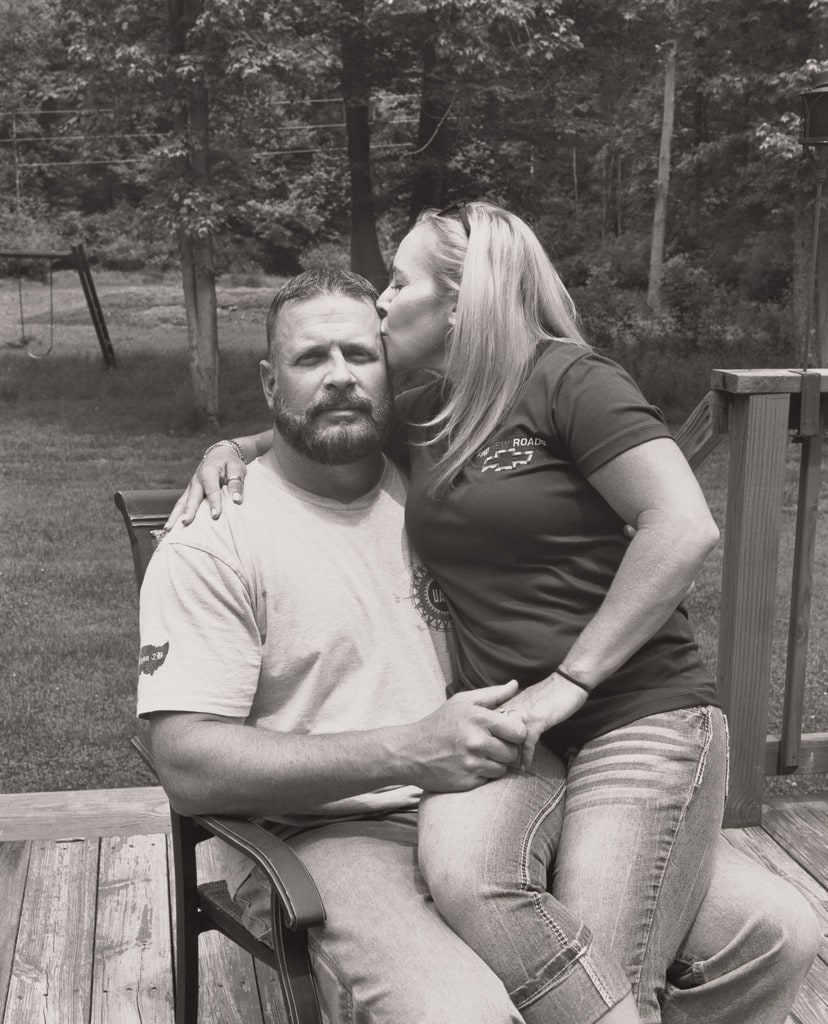 Tawnya Morgan, UAW Local 1112, kissing her husband Dan on their back deck, (23 years in at GM Lordstown Complex, trim shop, door line team leader), Hartford, OH
