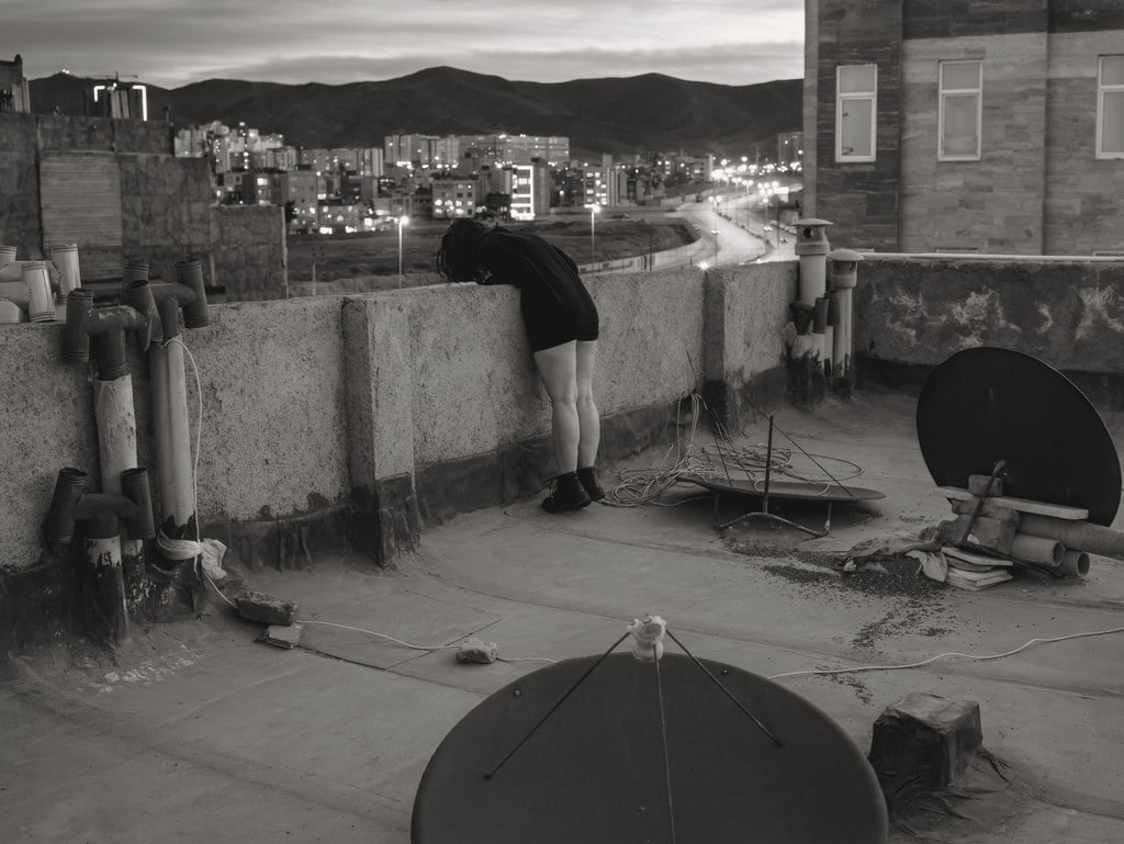 Untitled (girl looking down from rooftop)