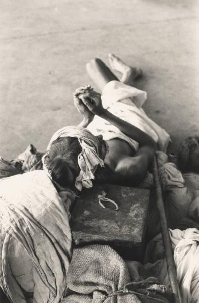 Worker Resting Against Luggage