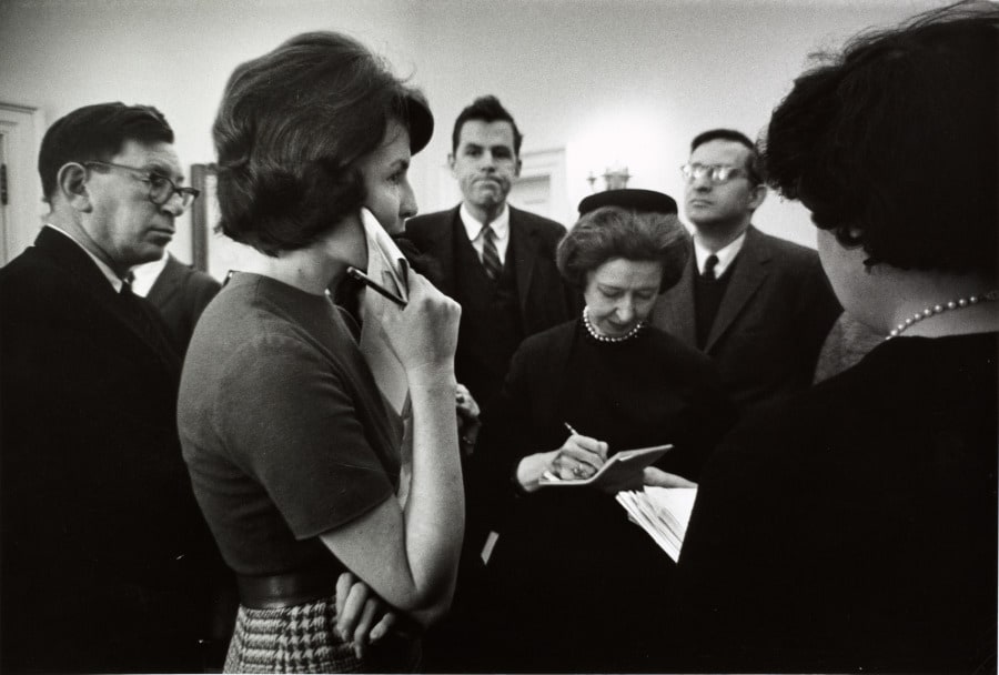 Press Secretary to the First Lady Pam Turnure standing with members of the press and White House officials