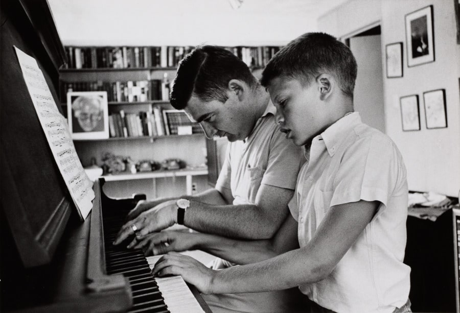 Press Secretary Pierre Salinger playing piano with son Marc