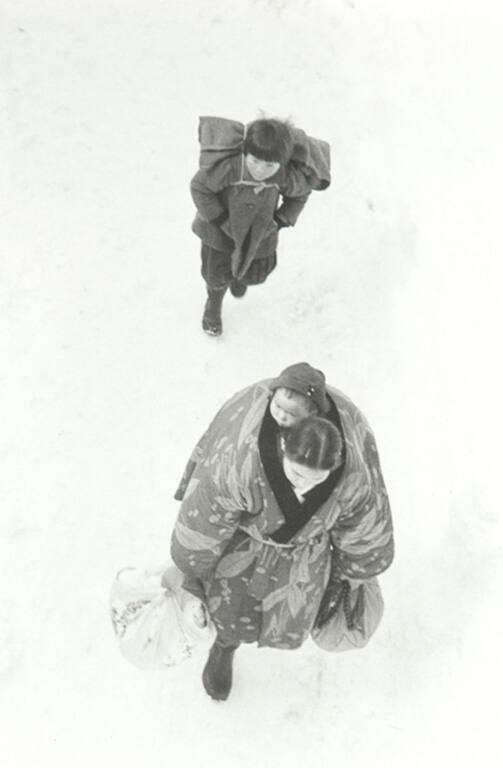 Mother and her kids on snow road of Echigo in Migata Prefecture