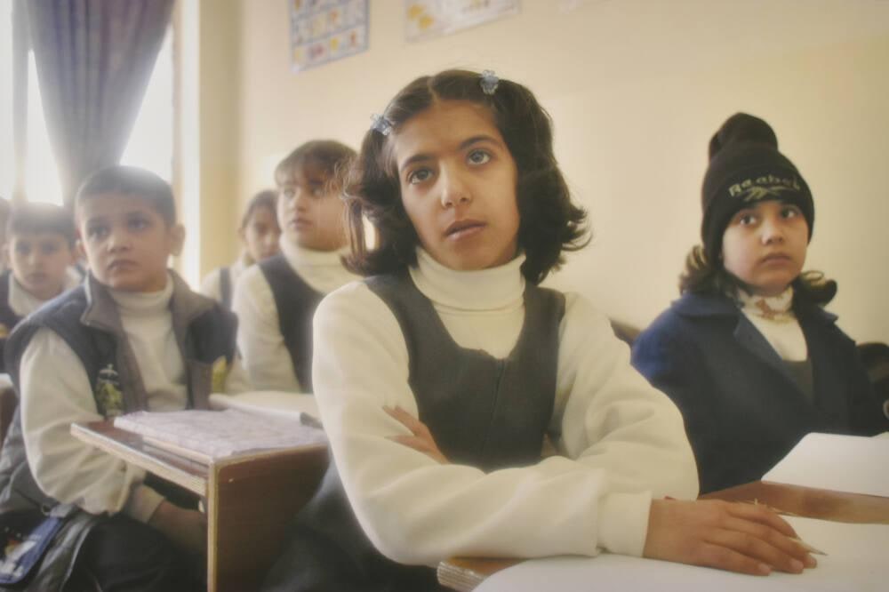 Fourth-grade students react to their teacher explaining that they may be killed by warplanes, should the U.S. invade