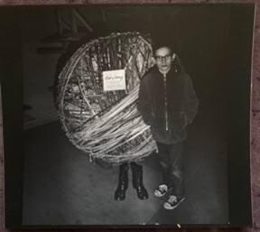 [Boy Standing in Front of “Ball of String” Pair of Legs]