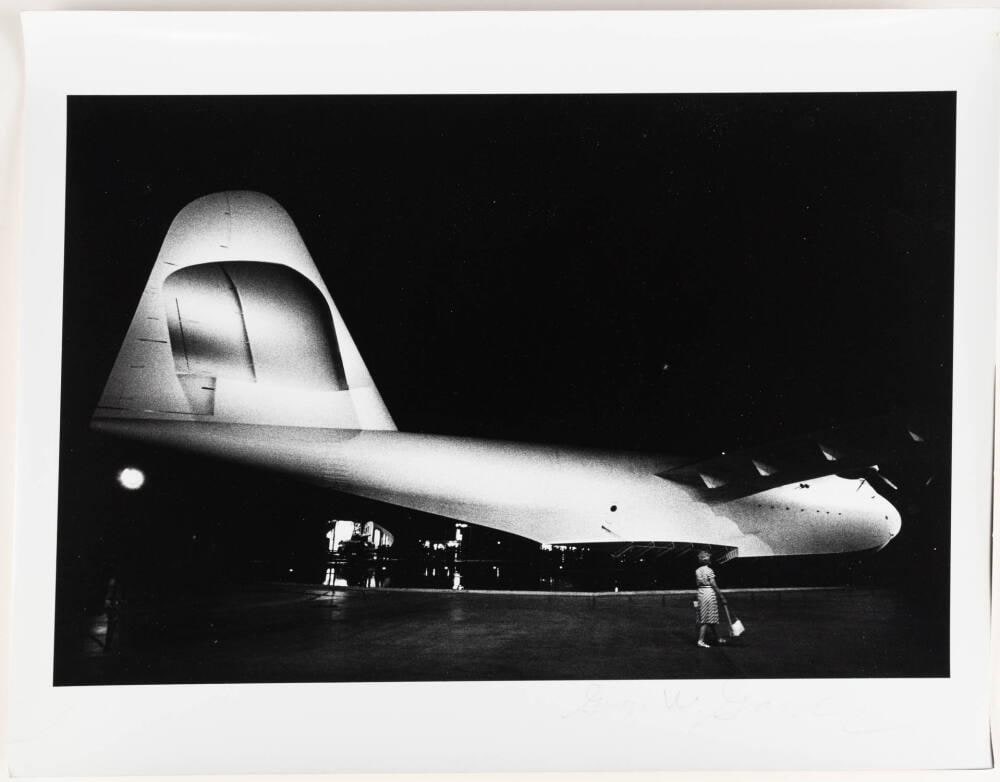 [Howard Hughes’ Spruce Goose Airplane, Woman with Purse]