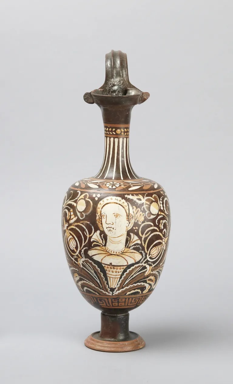 Trefoil oinochoe (jug) depicting a female head among flowers