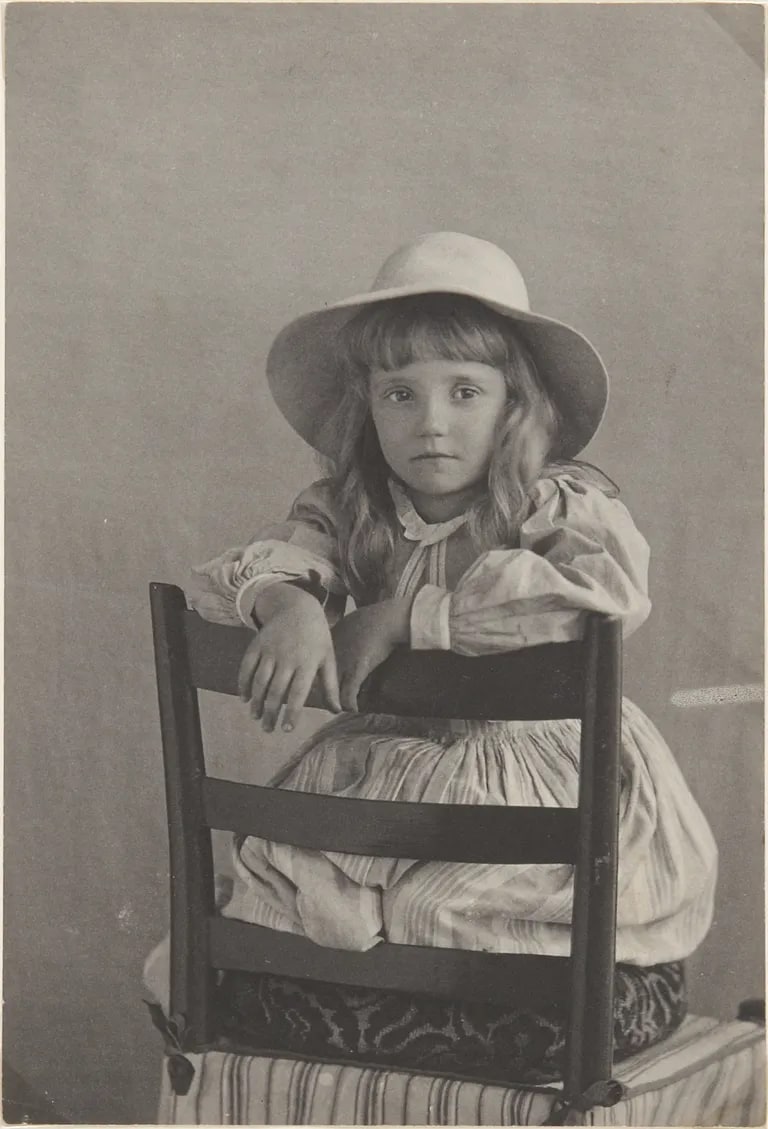 Mary W. Redfield leaning on back of chair