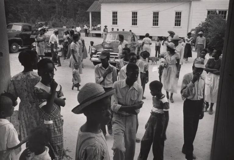 Schoolyard parking lot with people gathered to see Nurse Midwife, Maude Callen, South Carolina