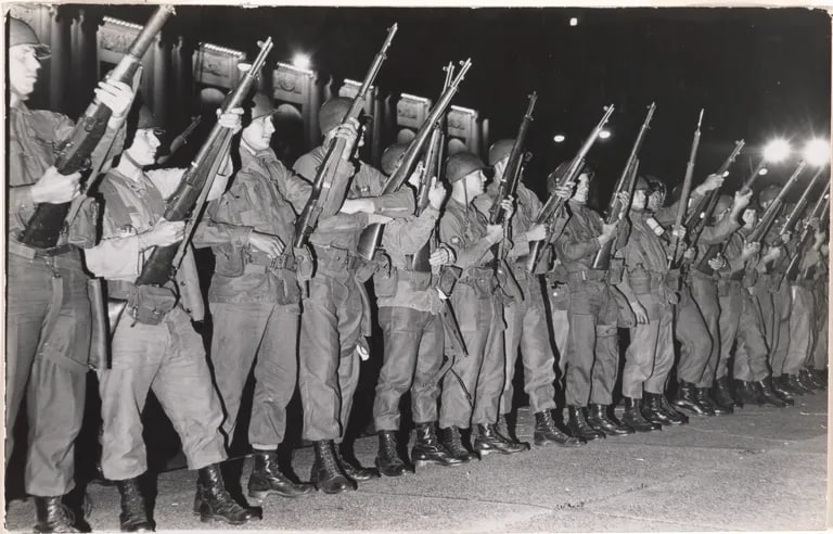 National Guard with loaded rifles wait for demonstrators