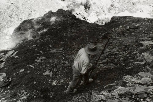 Man Climbing Rocky Area, viewed from above