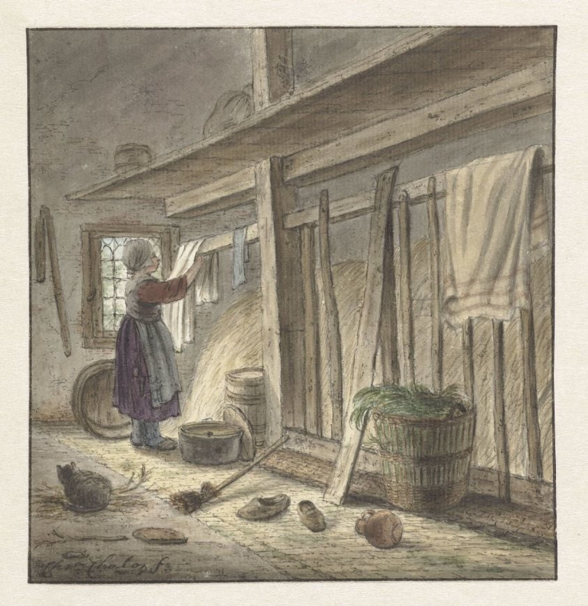Hoekje van een stal met een meisje dat een doek ophangt