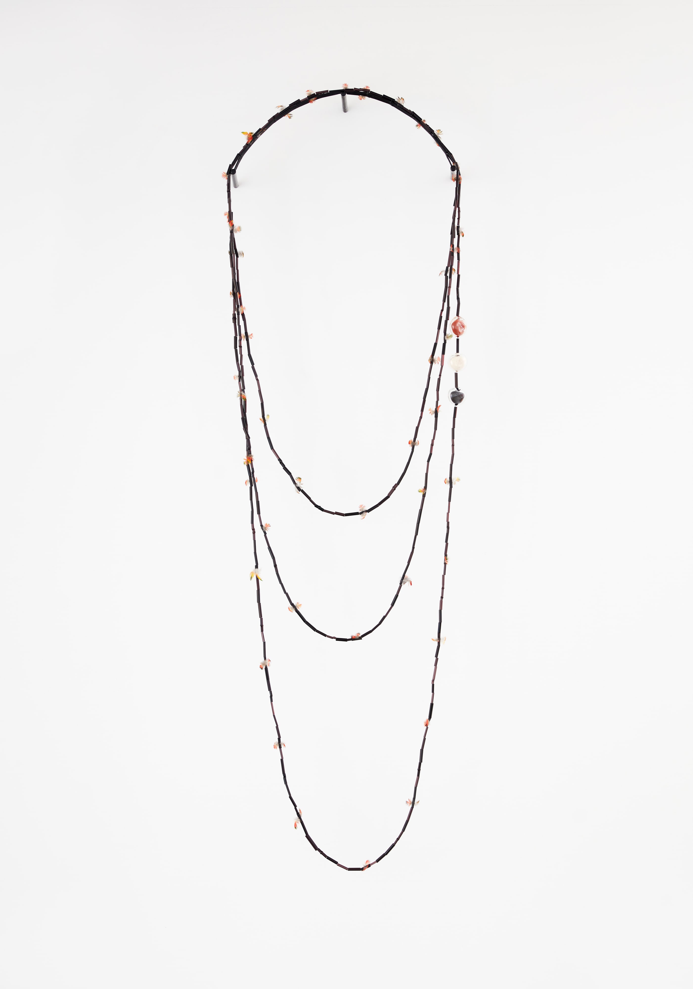Black glass necklace with red and green feathers and seed pods #1