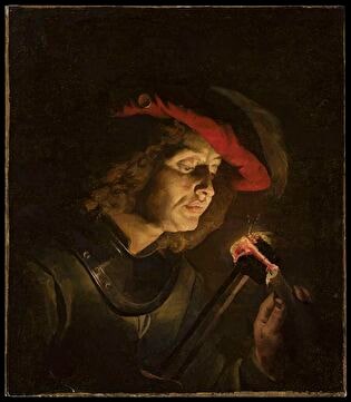 Soldier lighting a candle