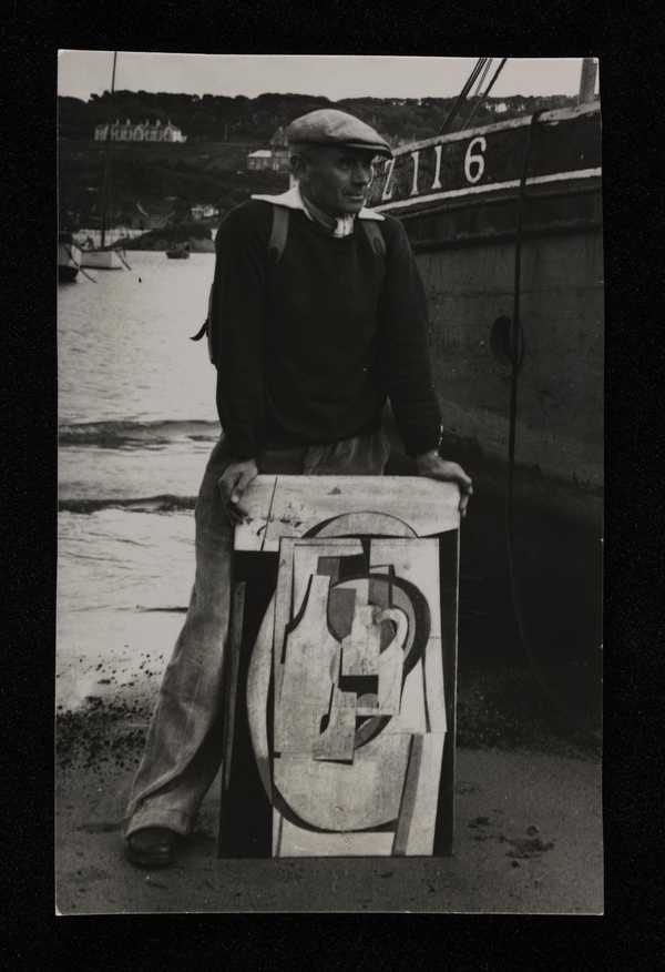 ‘Photograph of Ben Nicholson in Cornwall holding one of his works