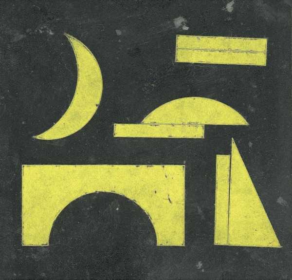 ‘Glass slide which has had pieces of yellow paper cut into geometric shapes glued onto it