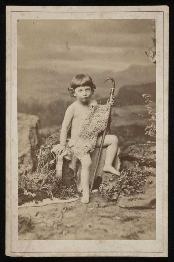 ‘Mounted photograph of Edmund von Motesiczky as a young child seated on a boulder dressed in a sheepskin toga, holding a shepherd’s crook