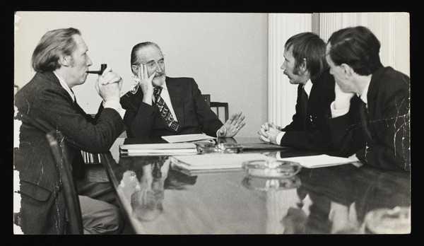 ‘Black and white photograph of Conrad Atkinson and Tony Durrell of the Artists’ Union talking to Hugh Jenkins, Minister for the Arts, about democratisation of the Arts Council