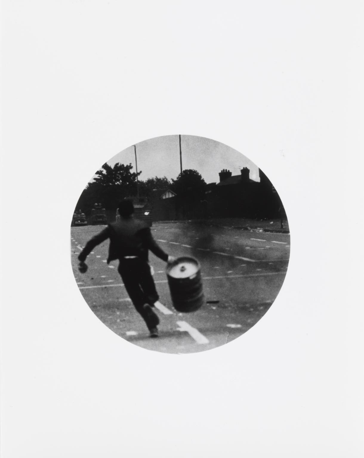 Untitled (Boy running with barrel)