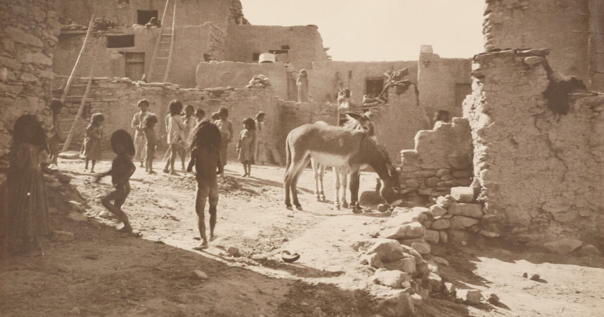 [Children at Indian pueblo with donkey]
