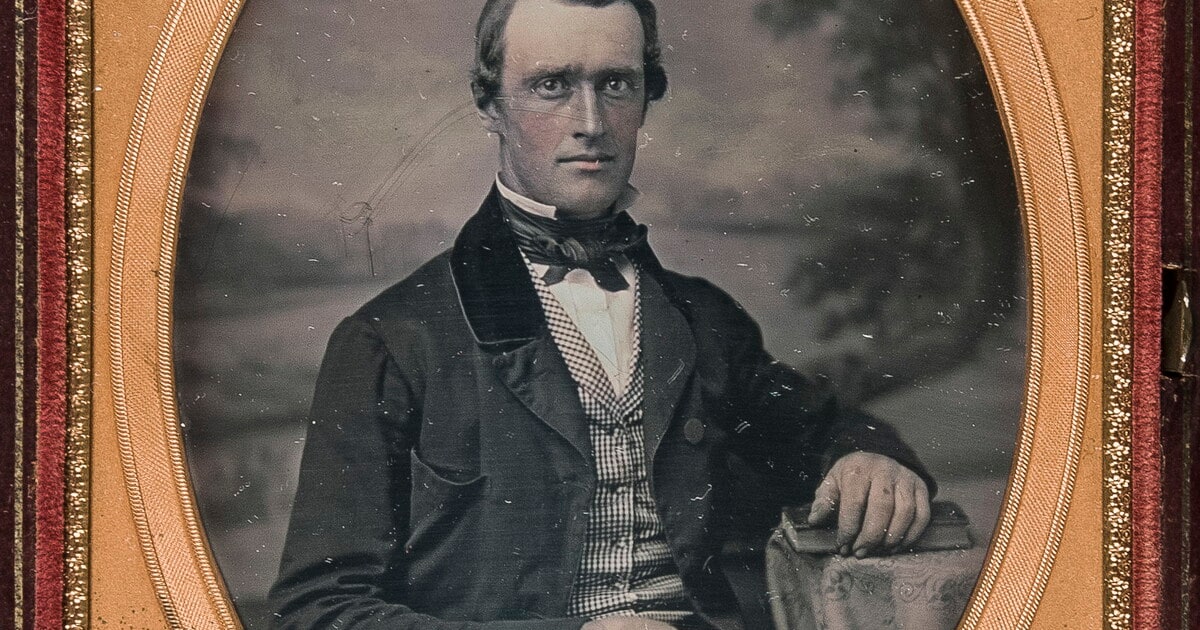 [Man, seated, arm resting on table]
