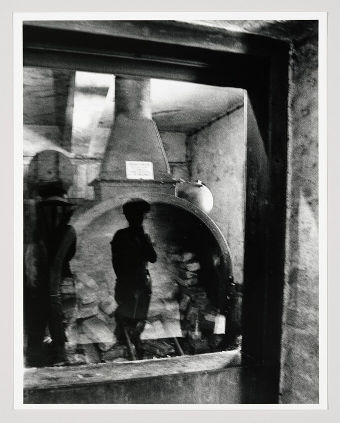 Reflection of Woman Viewing Oven, Auschwitz, Poland