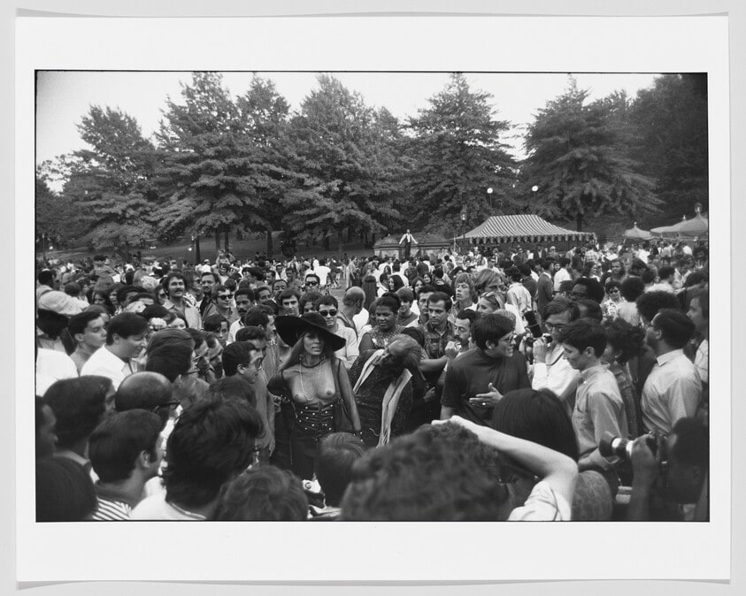 Crowd Gathered Around a Woman in See Through Dress
