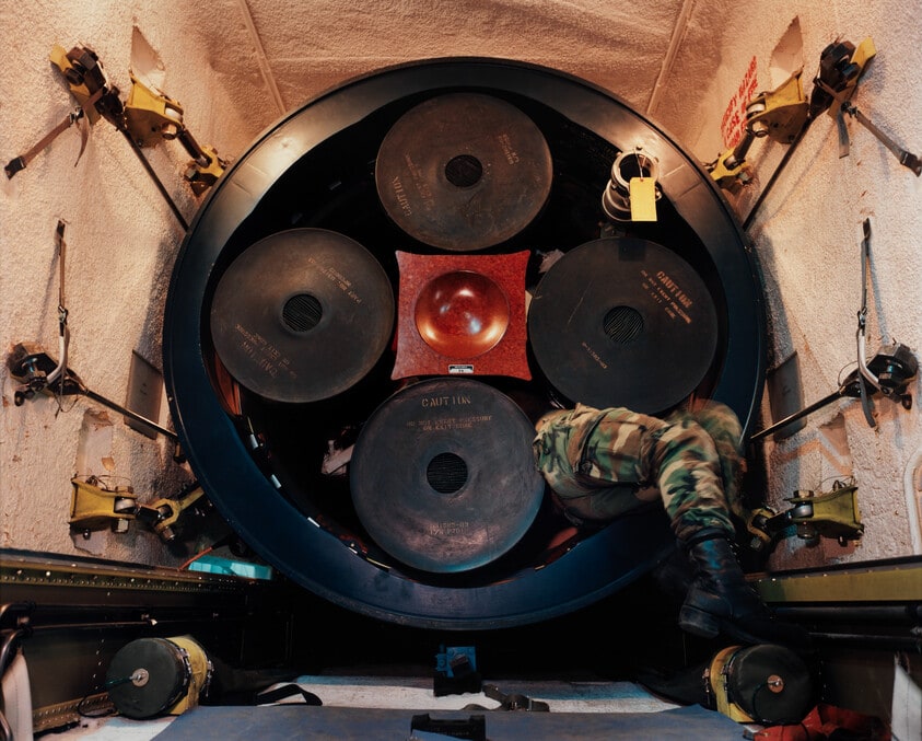 Untitled (Minuteman II missile in truck, technician preparing for transport in Transport Erector Vehicle, Ellsworth Air Force Base, South Dakota)