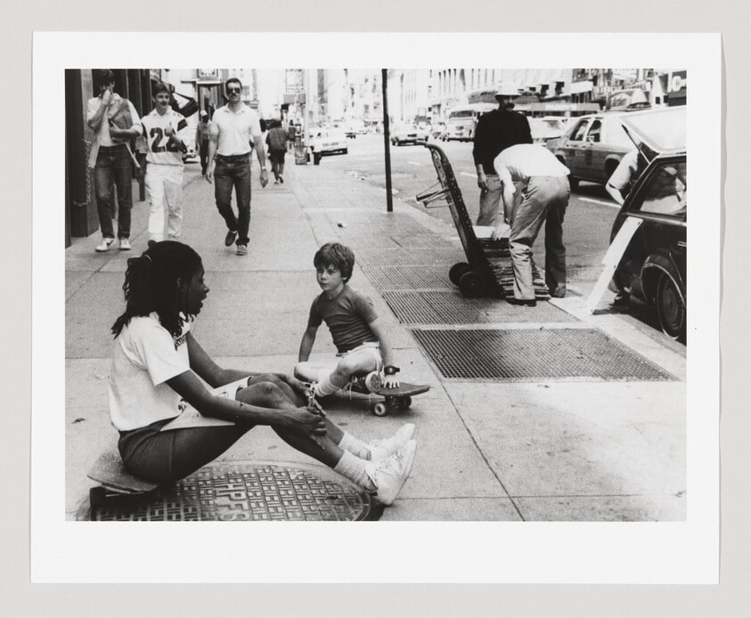 Untitled, New York (girl and young boy seated on skateboard in middle of sidewalk)