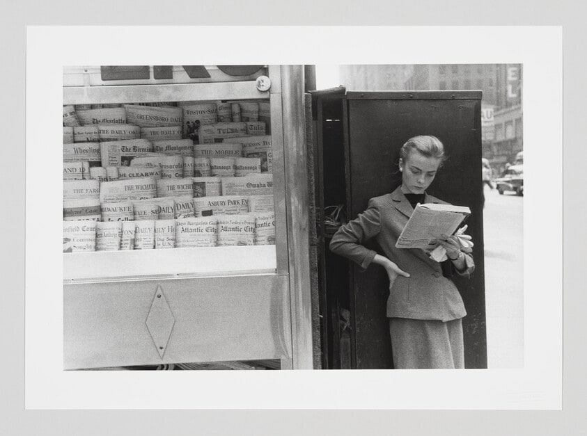 Woman Elbowing an Out of Town Newsstand