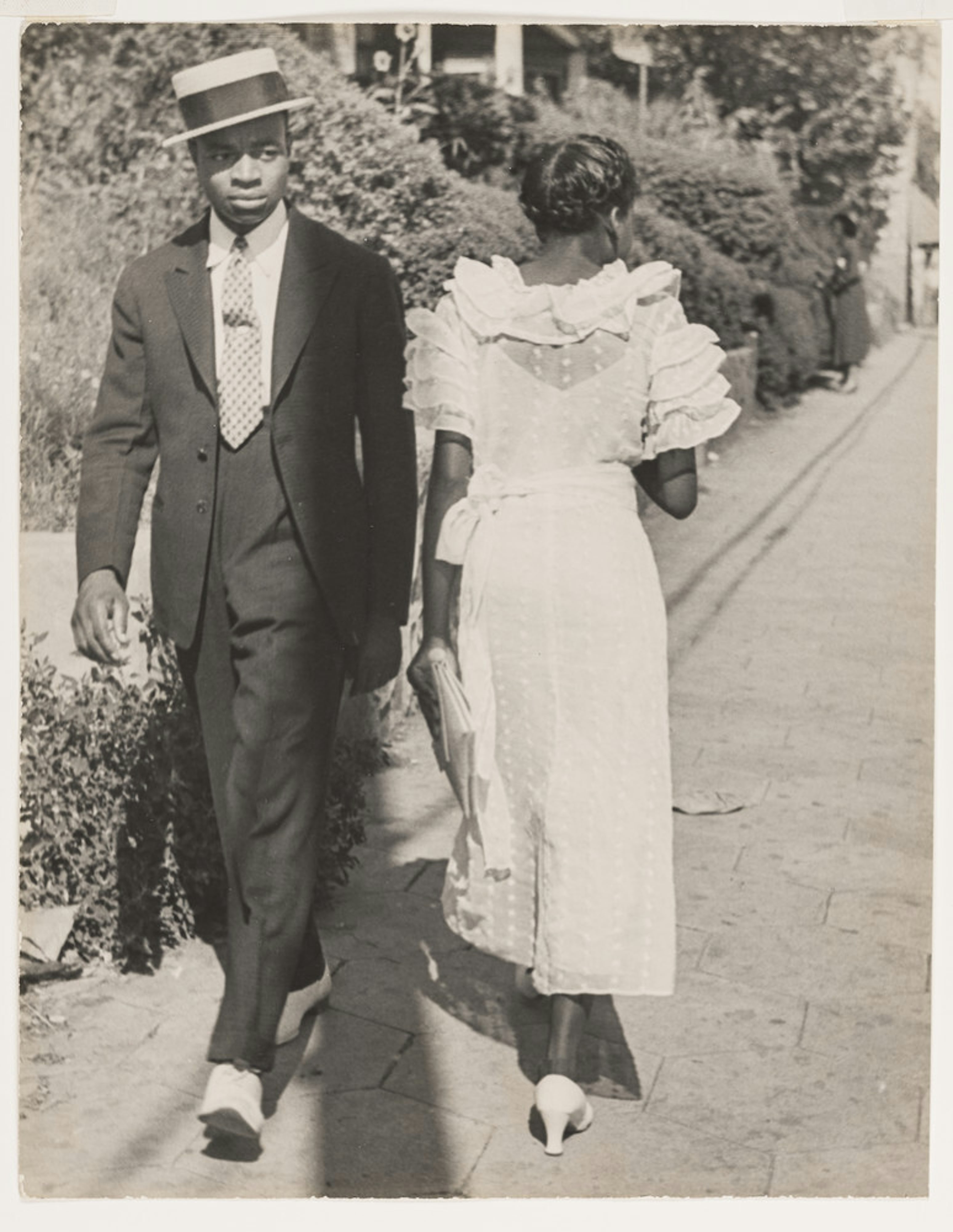 Young Black Man in His Sunday Best Eyeing Young Woman