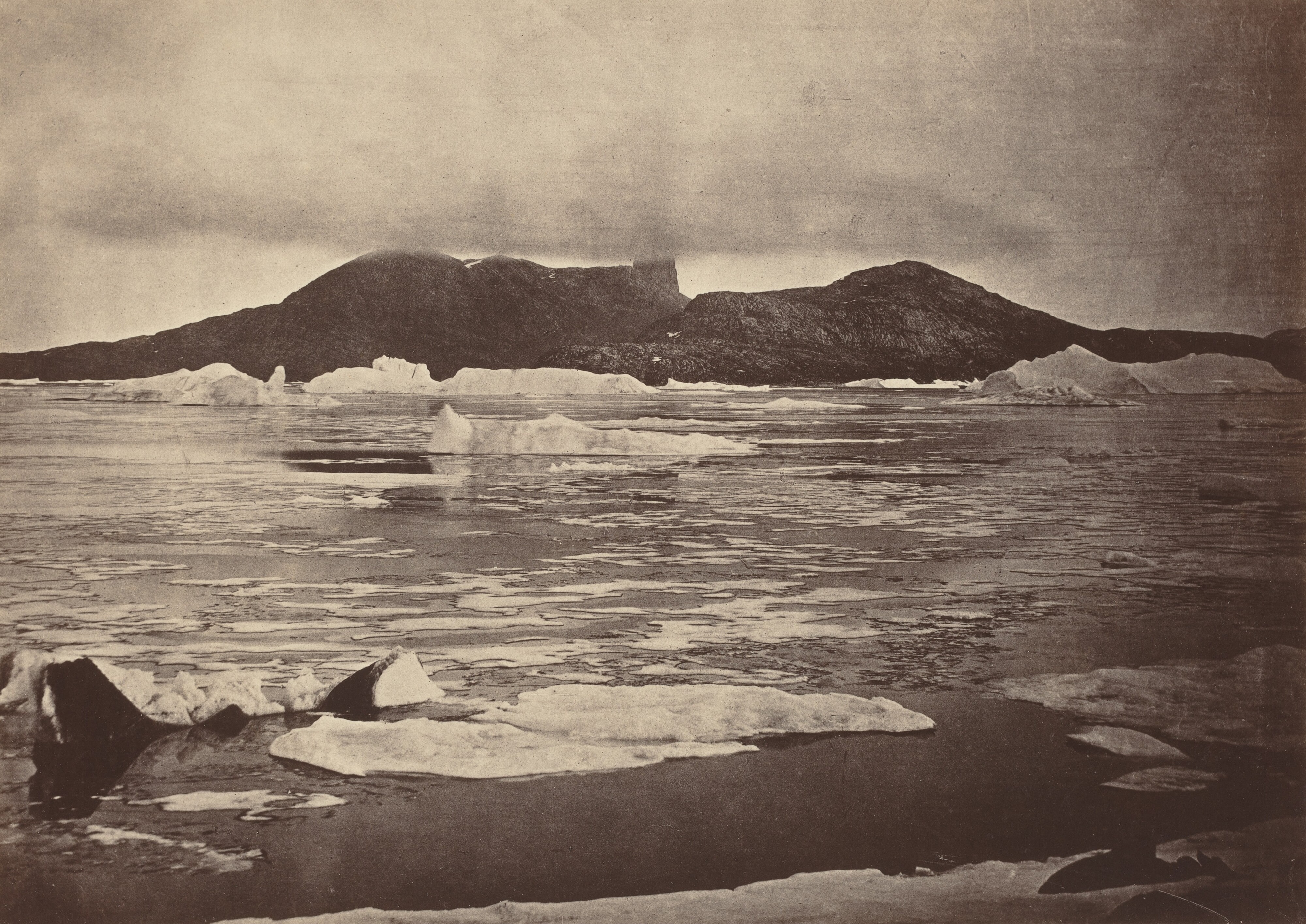 The Arctic Regions: No. 92.* The Devil's Thumb partially enveloped in a fog, with the first of the drift Ice from the pack, which was being forced towards the land, from which we escaped through a narrow lead; had we been hemmed in, we should have had to winter there