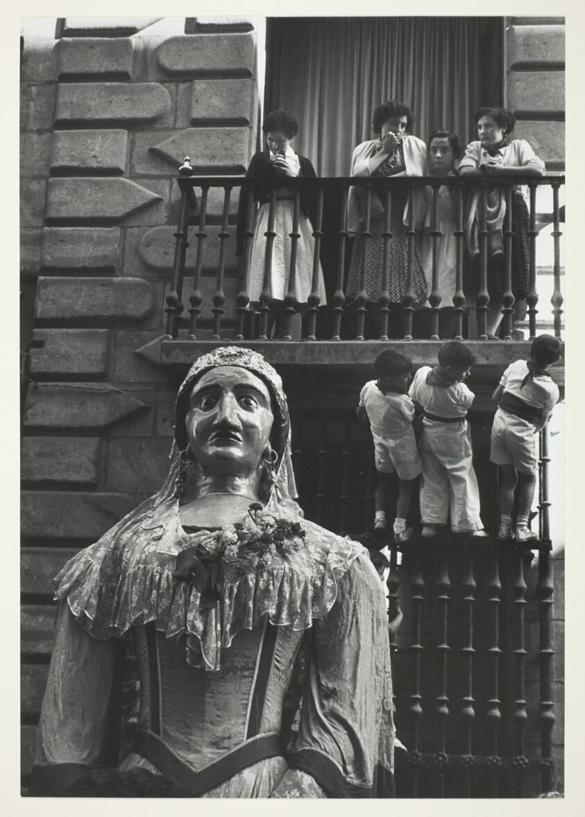 Pamploma: Large Figure in Foreground, Children on Balcony