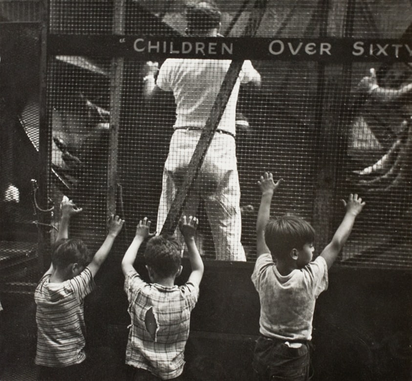 Untitled (Three Young Boys at the Fence of a Carnival Ride)