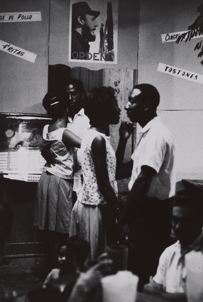 Men and Women Mingling under Poster of Castro, Santiago de Cuba