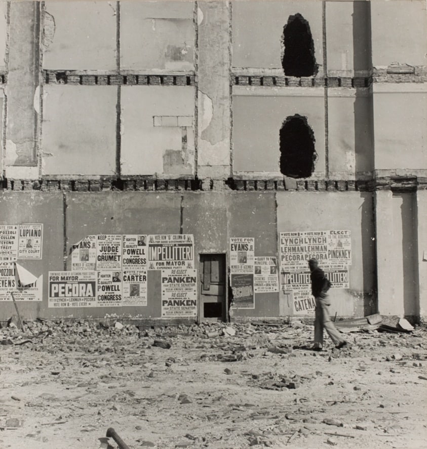 Untitled (Man Walking Past Building and Rubble)
