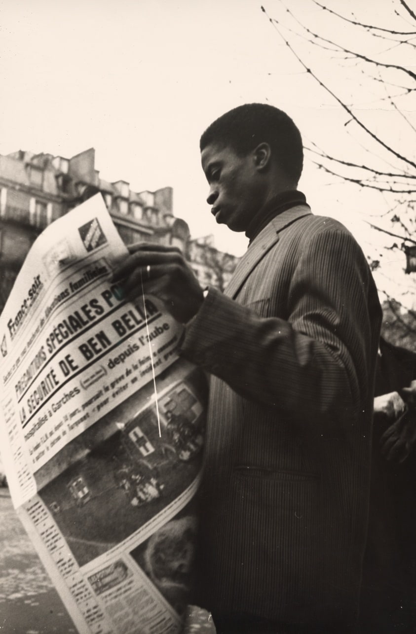Young Black Man Reading Newspaper