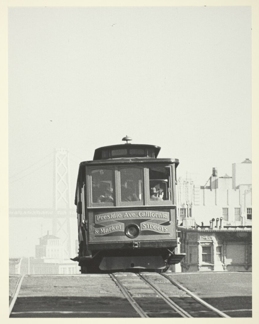 A Cable Car Tops Nob Hill; Tower of Bay Bridge in Background, San Francisco