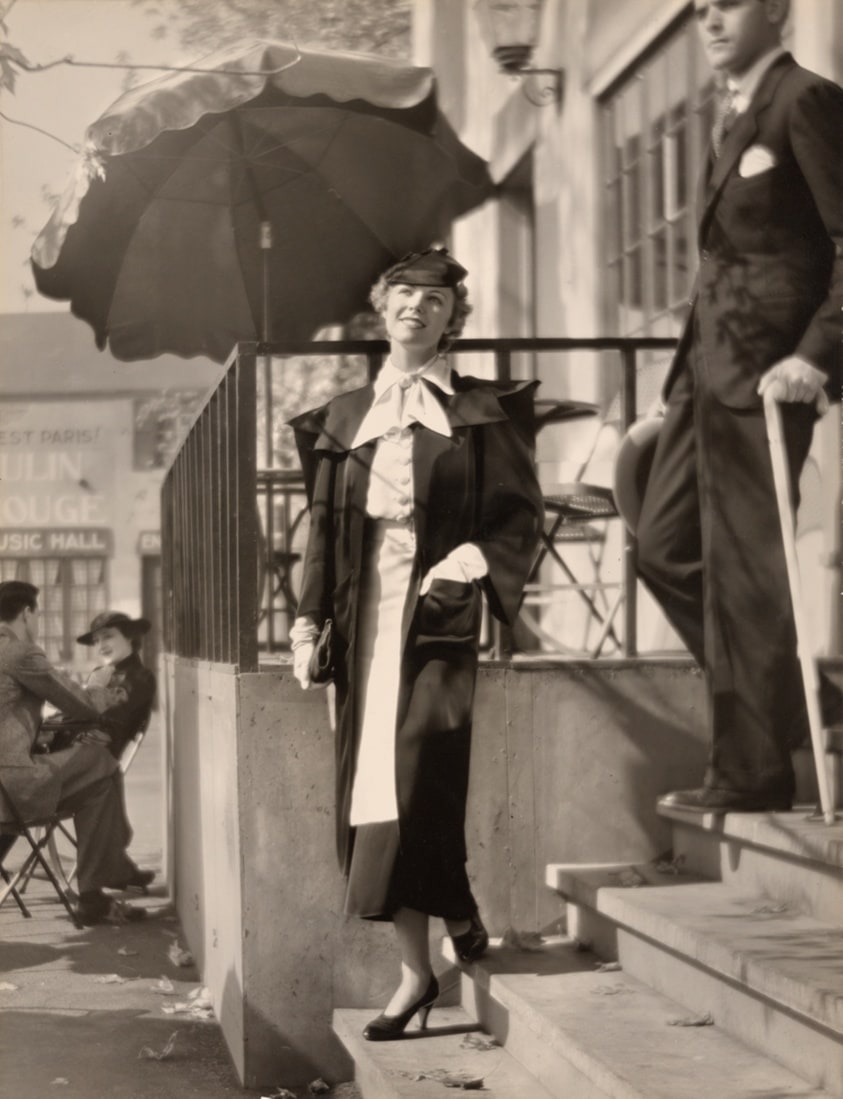Fashion photograph: Woman in White Gloves Descending Stairs with One Hand in Pocket