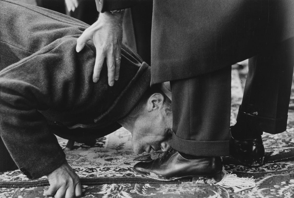 Paysan embrassant les pieds du Shah d'Iran