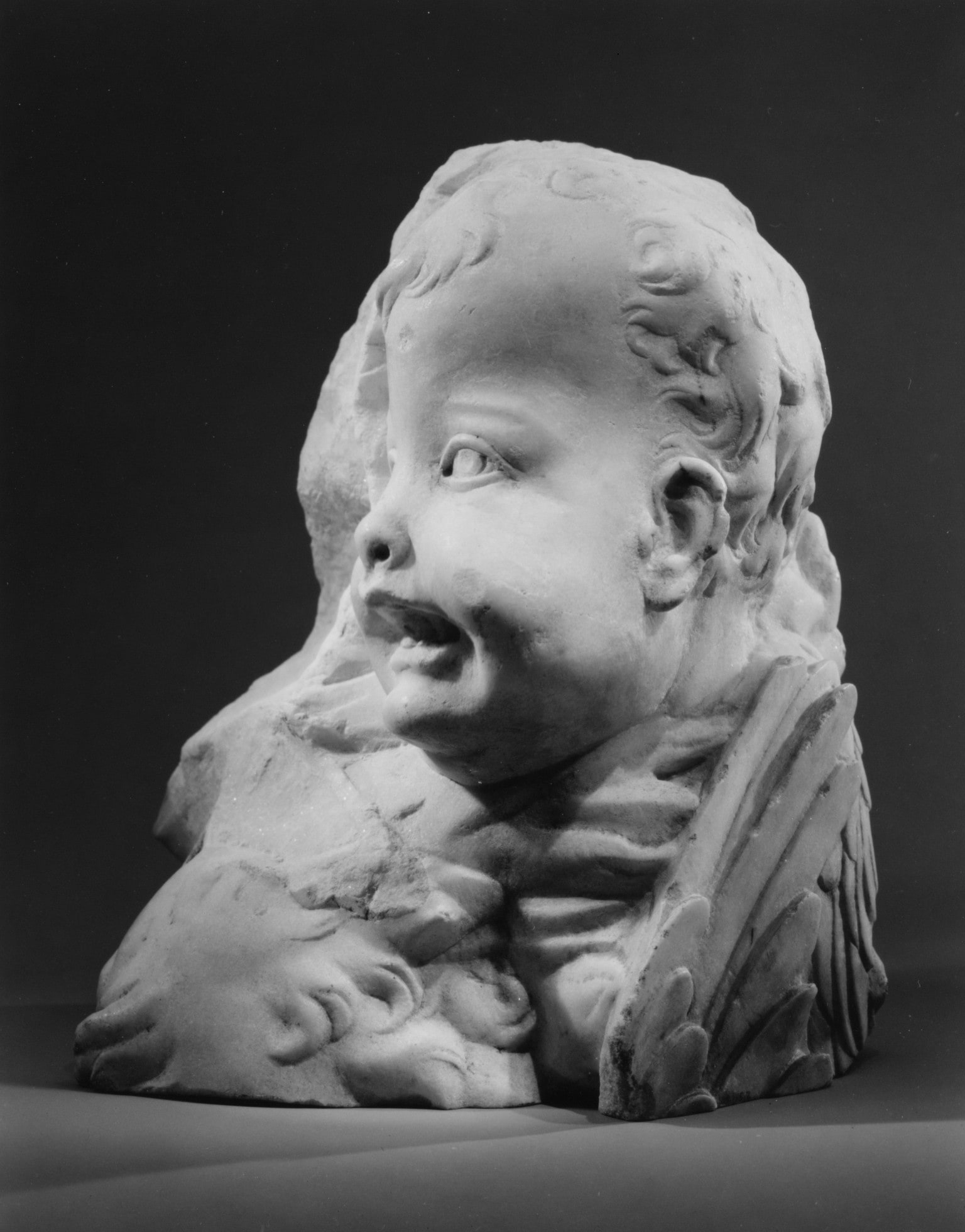 Head and wings of an angel and forehead of another
