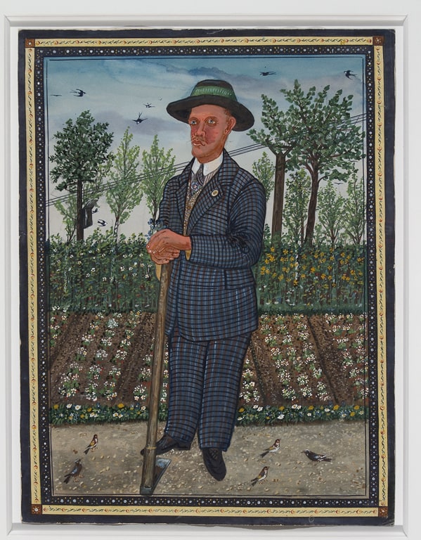 Man Standing in Front of Flowerbed with Garden