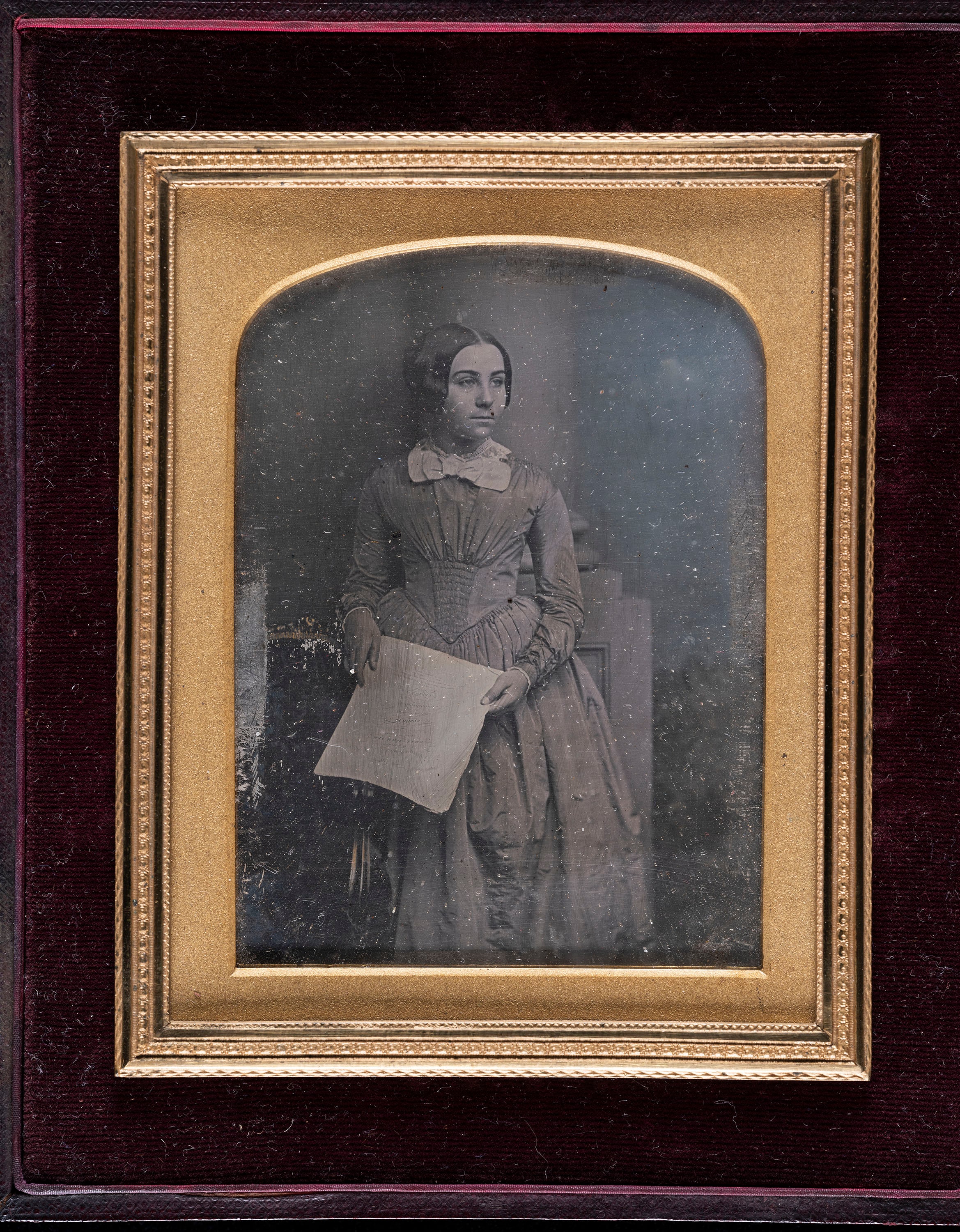 Portrait of a woman with a sheet music