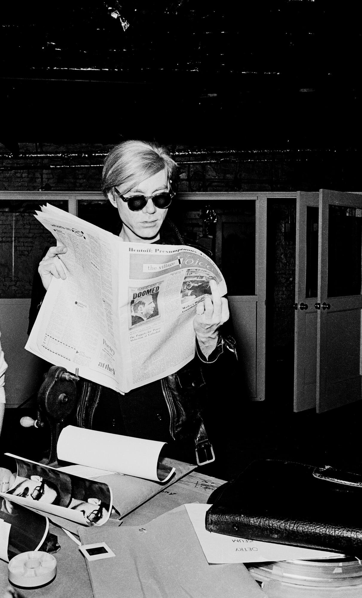 Andy Warhol at the Factory, reading the Village Voice, N.Y. 1968